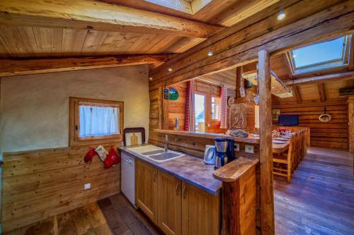 a kitchen in a log cabin with a counter top at Chalet Beaufortain La Pachna in Hauteluce
