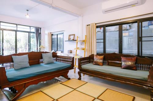 sala de estar con 2 sofás y ventanas en LD8 House Private Pool Perfect Groups -Families ChiangMai, en Chiang Mai