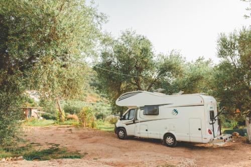 a white camper truck parked on a dirt road at Unique Stay at Olive Camping in Himare