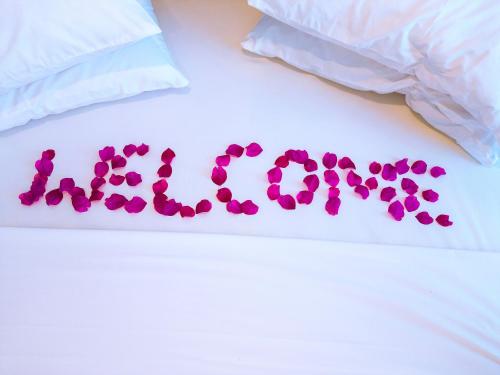 a word made out of hearts on a bed at Limiria Villa Zanzibar in Nungwi