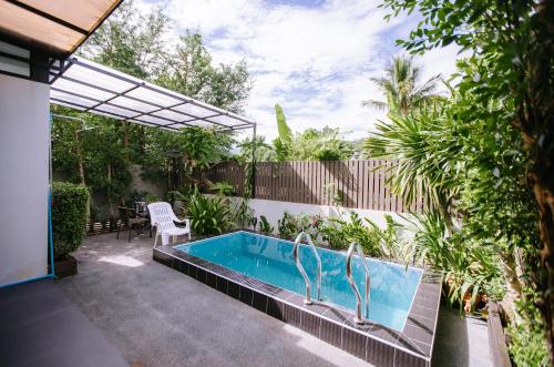 a swimming pool in the backyard of a house at Private House - Pool - Best Location - Groups & Families ChiangMai in Chiang Mai