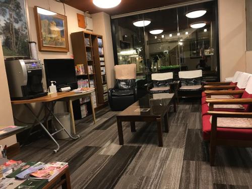 a salon with tables and chairs in a room at Aizu Tsuruya Hotel - Vacation STAY 57216v in Aizuwakamatsu