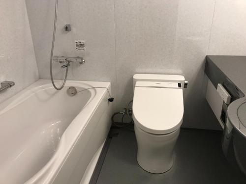 a bathroom with a toilet and a bath tub at Aizu Tsuruya Hotel - Vacation STAY 57204v in Aizuwakamatsu