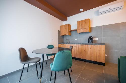 a kitchen with a table and chairs in a room at Porta Nuova Luxury Apartments in Turin