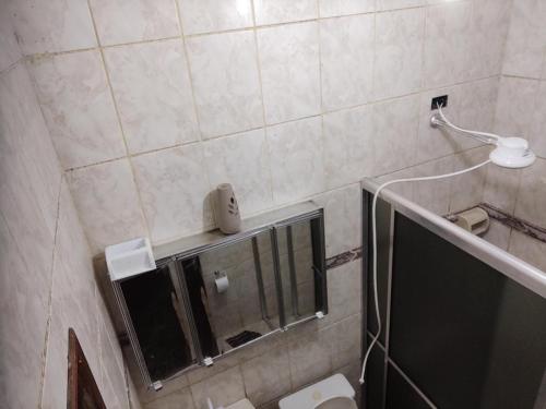 a small bathroom with a shower and a toilet at Casa ilha comprida in Ilha Comprida