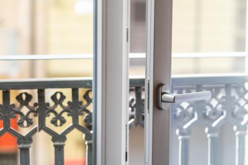 a glass door with a handle on a balcony at Porta Nuova Luxury Apartments in Turin