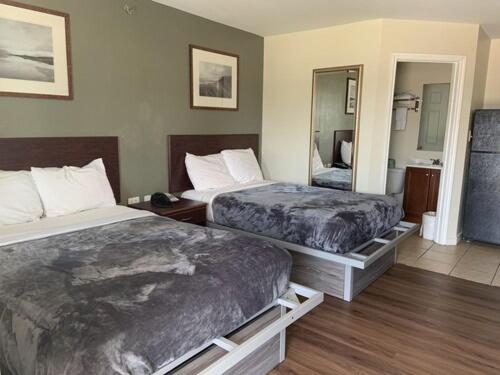 Postel nebo postele na pokoji v ubytování Paris Extended Stay Suites