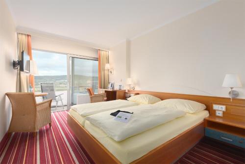 เตียงในห้องที่ Trip Inn Landhotel Badsoden-Salmünster