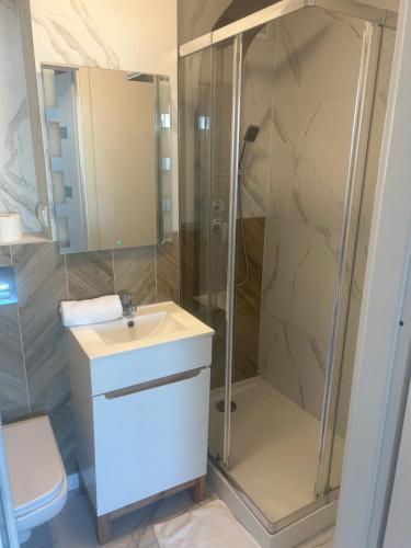 a bathroom with a shower and a sink at TopOne Apartments in Warsaw