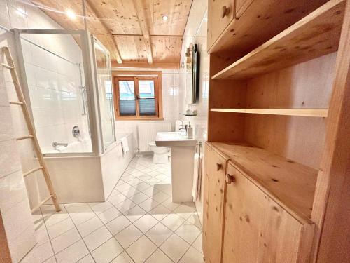 a bathroom with a shower and a sink and a toilet at Ferienhaus "Gipfelstürmer" in Bayrischzell