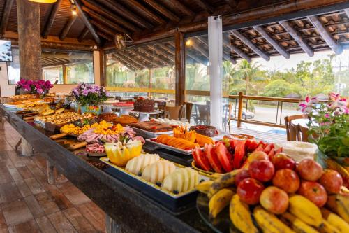 a buffet line with many different types of fruits and vegetables at Imperatriz Paraty Hotel in Paraty
