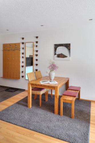 a dining room with a table and two chairs at Hölderle Damüls in Damuls
