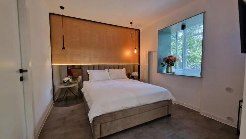 a bedroom with a large bed and a window at Start Apartments 3 in Bucharest