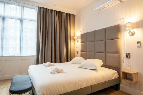 Un ou plusieurs lits dans un hébergement de l'établissement Les Suites Faidherbe