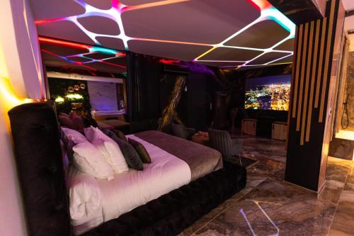 a bedroom with a bed in a room with lights at Krystalisya Room Suite Spa Privatif Sauna Jacuzzi Siege Massant in Marseille