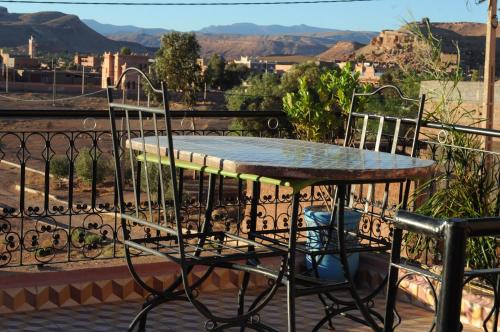a table and chairs on a balcony with a view at CHEZ MANAR in Ouarzazate