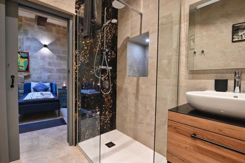 a bathroom with a sink and a shower at Il Luzzu - more room for you! in Victoria