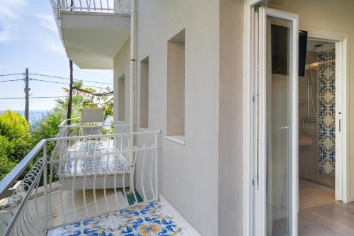 a balcony with blue and white tiles on the stairs at Hotel Rivage Taormina in Taormina