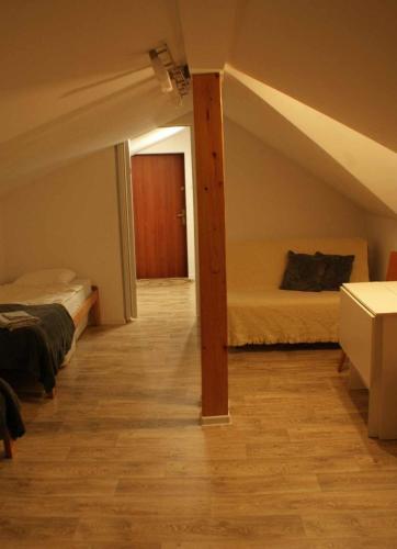 a attic room with two beds and a hallway at Domek w Karkonoszach Stary Eden in Karpacz