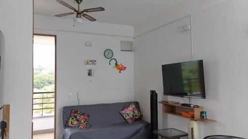 a living room with a couch and a flat screen tv at Disfruta en Paraíso del Sol T9-402 in San Jerónimo
