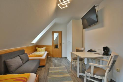 a living room with a couch and a table at Pension Bergstube in Bad Langensalza