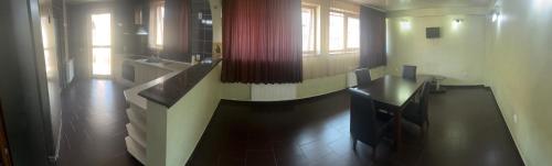 a kitchen with a table and a counter in a room at Complex Ramiro in Suceava