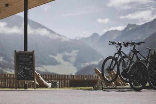 a group of bikes parked next to a sign with mountains at Stoana Apt 4-2 in San Giacomo