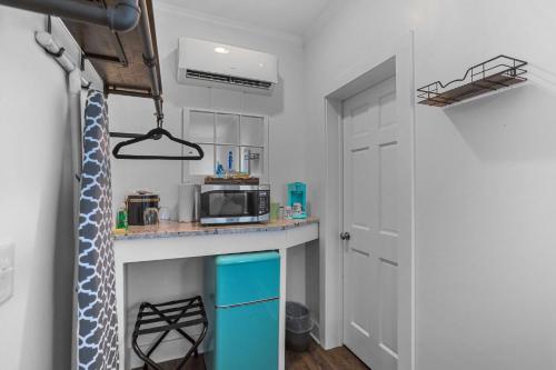 a small kitchen with a counter and a microwave at Little Inn on Main in Washington