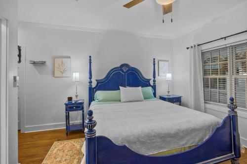 a blue bed in a white room with two blue tables at Little Inn on Main in Washington