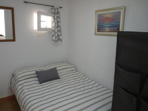a bed in a room with a pillow on it at Modern Apartment Near Beach in La Mata