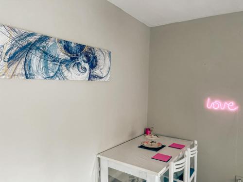 a room with a table and a sign that says love at THE CHEAPEST IN THE CITY Sagittarius in Komotini