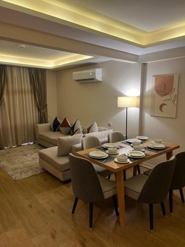 a living room with a table and a couch at مخصص للعوائل فقط Four Elements in Cairo