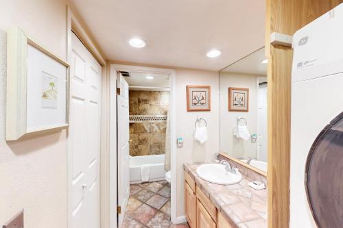 a bathroom with a sink and a tub at Summit House East 113 in Copper Mountain