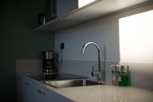 a kitchen with a sink and a counter top at Loft Trevisan Elegant Apartment in Bra with Private Garage in Bra