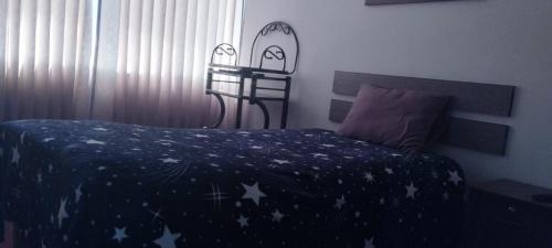 a bedroom with a bed with stars on it at Hostal Los Andes - Espinar in Espinar