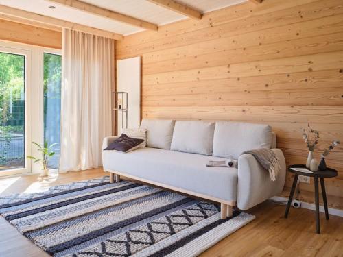 a white couch in a room with wooden walls at Chalet in Köln - Tinyhouse in Cologne