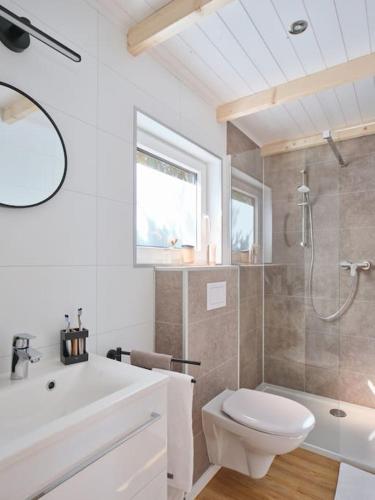 a white bathroom with a toilet and a shower at Chalet in Köln - Tinyhouse in Cologne
