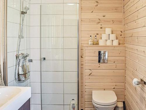 a bathroom with a toilet and a shower at Holiday home Fall in Raufoss