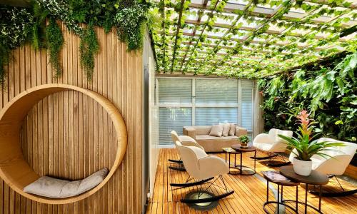 a living room with a lot of plants at Hotel 5 Elementos Corferias by HBP in Bogotá