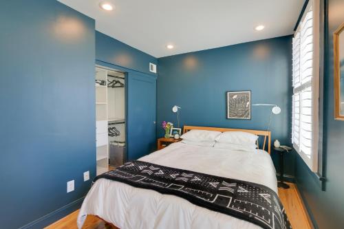 una camera da letto con pareti blu e un grande letto di 2 Mi to National Mall Stunning Townhome with Patio! a Washington