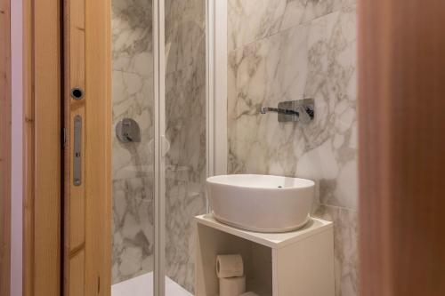 a bathroom with a sink and a shower at Buffaure a parte in Pozza di Fassa
