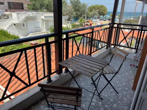 a balcony with a bench and a view of a street at Salty Breeze #Hosted by DoorMat in Neoi Epivates
