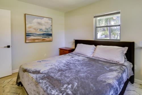 a bedroom with a bed and a window at Dog-Friendly Vero Beach Retreat with Porch and Grill! in Vero Beach