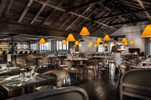 a restaurant with people working at tables and chairs at Mountain Vista Luxury Retreat! in Pound Ridge