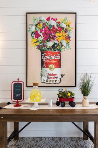 a table with a can of coca cola with flowers at Biddle Point Inn in Plymouth