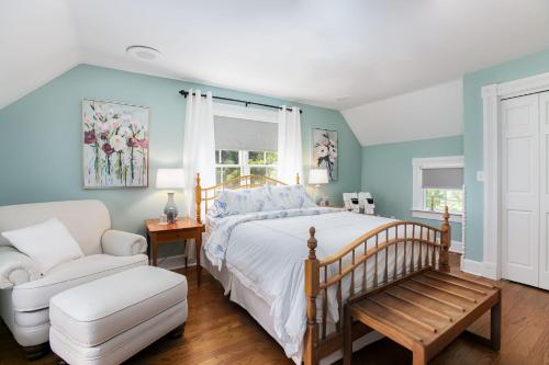 a bedroom with a bed and a chair at Biddle Point Inn in Plymouth