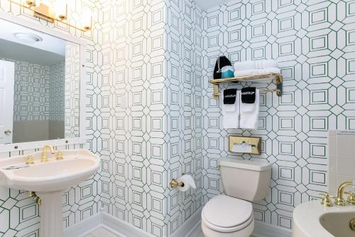 a bathroom with a toilet and a sink and a mirror at Biddle Point Inn in Plymouth