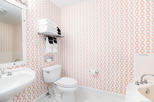 a bathroom with a white toilet and a sink at Biddle Point Inn in Plymouth