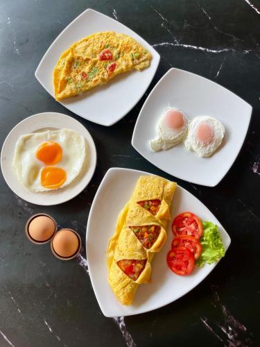 four plates of breakfast foods on a table at Pen's Bungalow Koh Phangan in Thong Nai Pan Yai