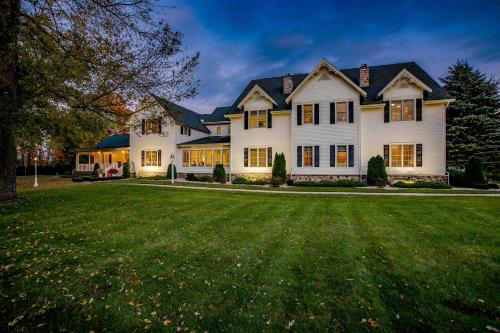 a large white house with a large yard at Biddle Point Inn in Plymouth